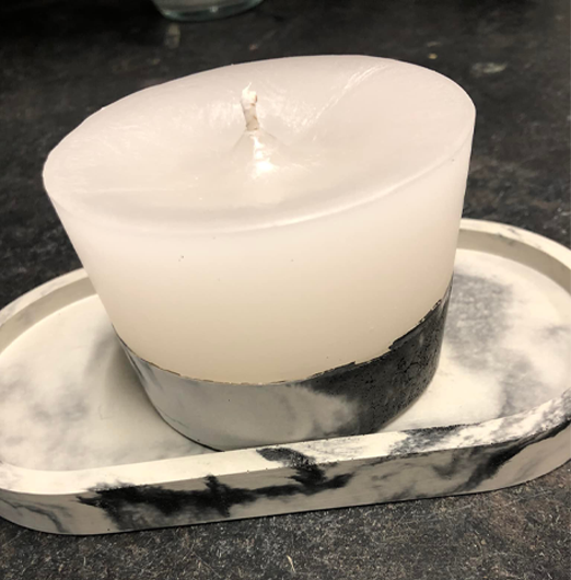 An open white-wax candle